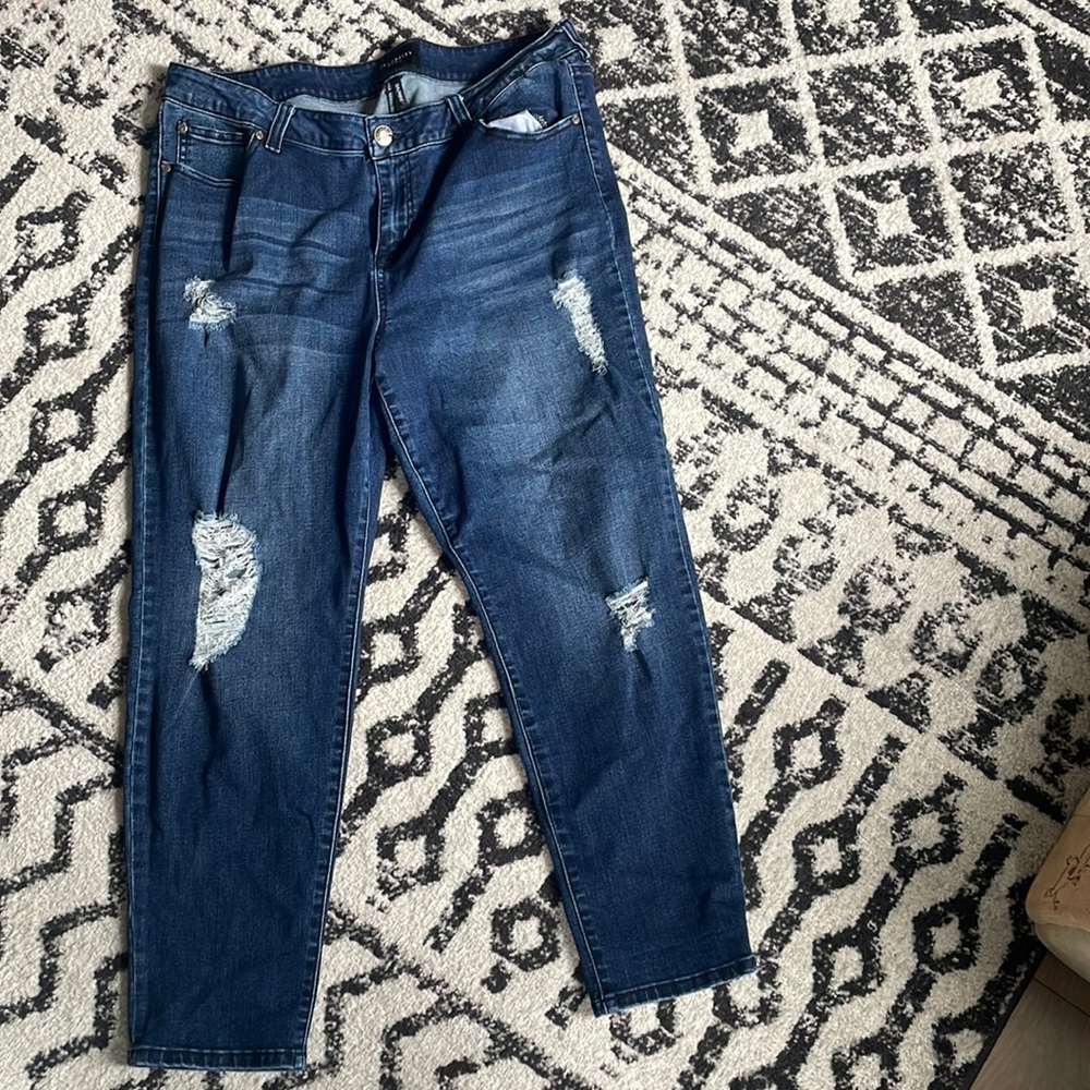 Distressed dark denim jeans